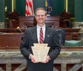 May 26, 2015 – Senator Hutchinson takes a photo with a plaque that was given to him and signed by the members of Boy Scout Troop 58 from Butler, Pennsylvania. 05/26/15
