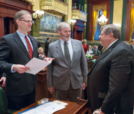 January 6, 2015 – Senator Hutchinson talks with colleagues on the Senate floor during Swearing-In Day activities. 01/06/15